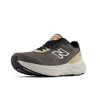 Gray running shoe with beige accents on a white background