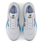 White New Balance 880 running shoes with blue accents on a white background