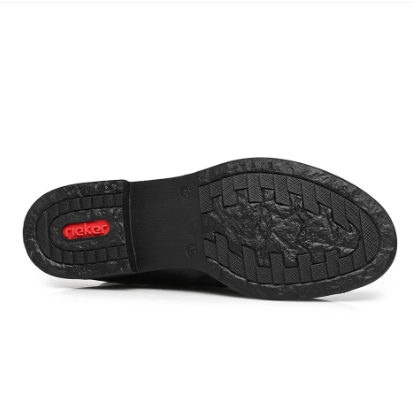 A close-up of a black shoe sole, showing the tread pattern on the bottom and a red 'rieker
' logo on the heel, set against a plain white background.