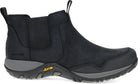 A black Chelsea-style ankle boot with a black suede and fabric upper, elastic side panels, and a gray Vibram sole, shown from a side profile on a white background.