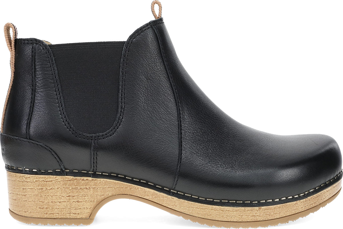 A black leather Chelsea boot with a natural cork-look stacked heel and sole, shown from a side profile view on a white background.