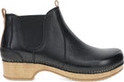 A black leather Chelsea boot with a natural cork-look stacked heel and sole, shown from a side profile view on a white background.
