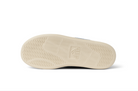 Close-up of a shoe sole with a brand logo on a white background