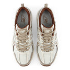 A pair of New Balance 530 sneakers shown from a top-down view on a white background. The shoes feature a cream and beige mesh upper with brown accents, including the lining, tongue, and outsole.