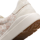 Close-up of a beige sneaker with a white sole on a white background