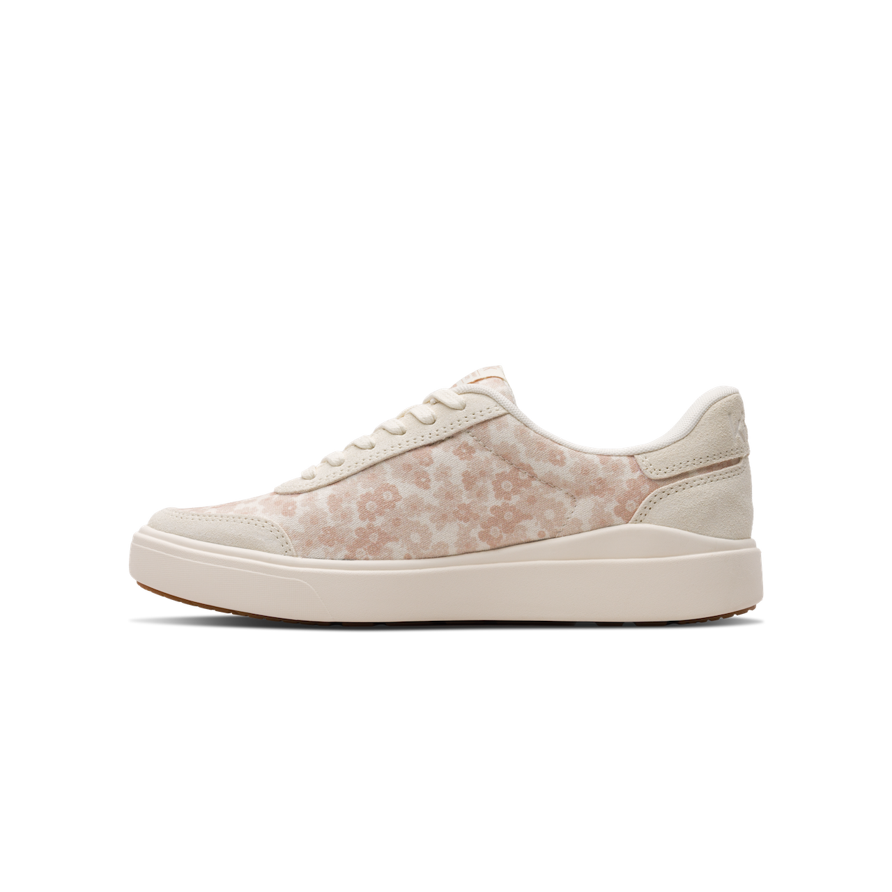 Beige sneaker with subtle pattern on a white background
