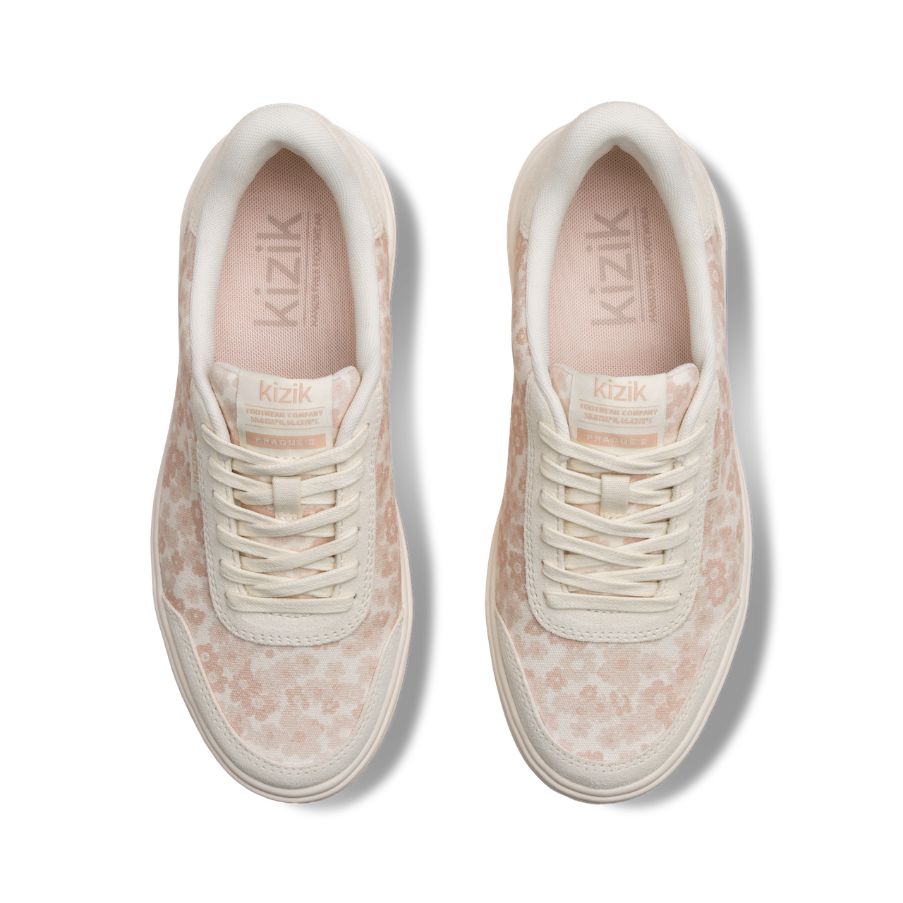 Pair of cream sneakers with subtle pattern on a white background