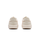 Pair of beige sneakers on a white background