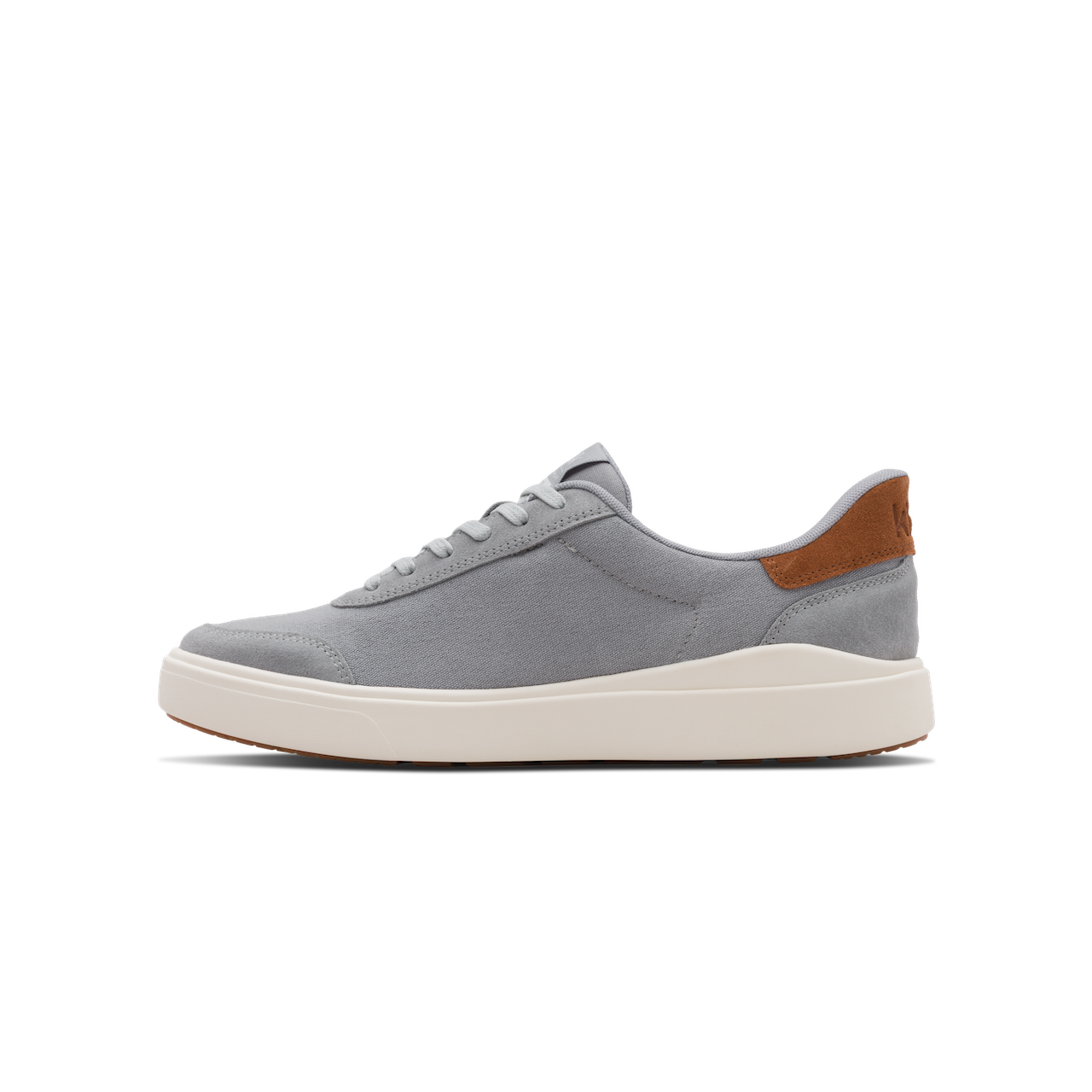 Gray sneaker with a brown heel tab on a white background