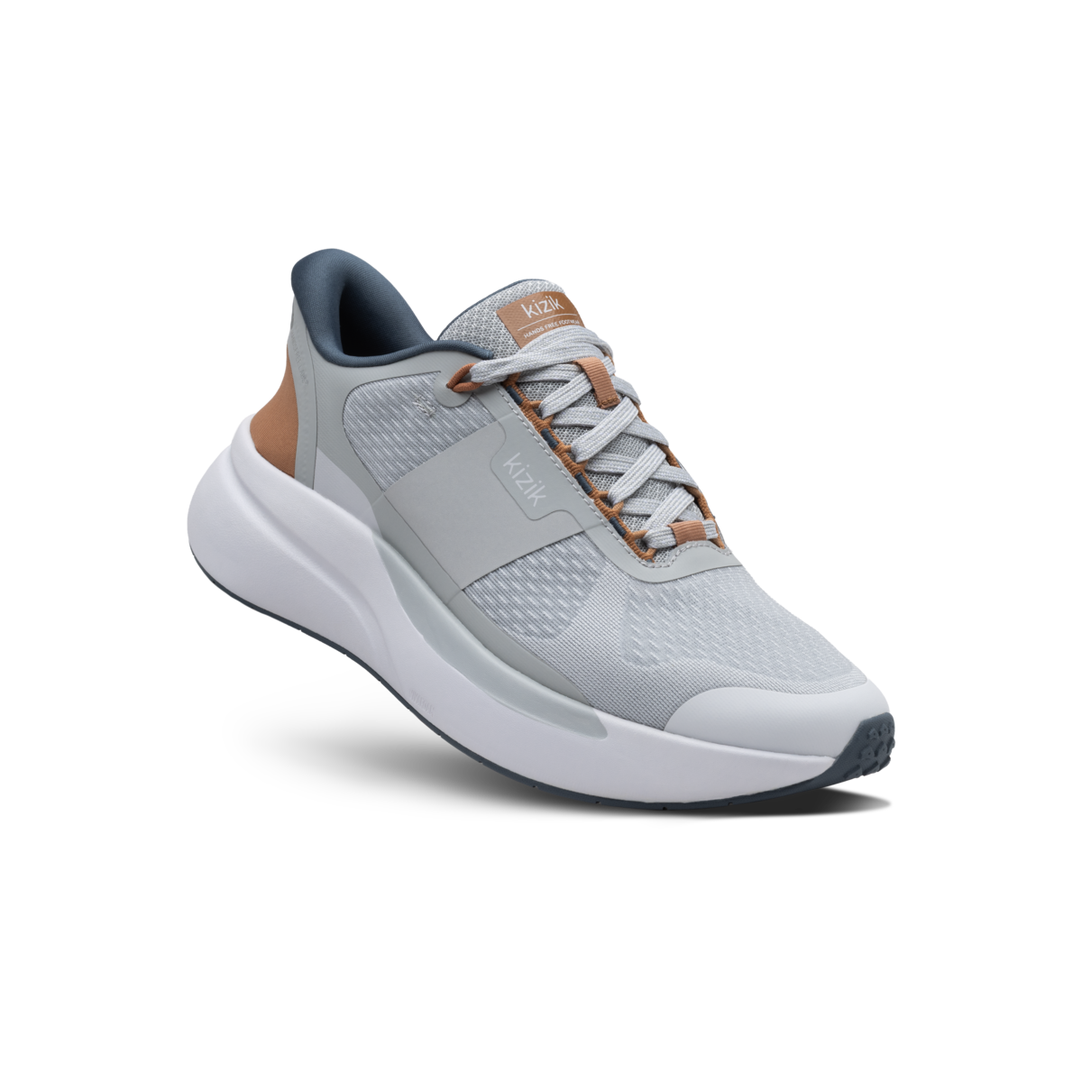 Gray athletic shoe with brown accents on a black background