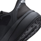 Close-up of a black athletic shoe showing the heel, collar lining, and textured outsole against a white background.