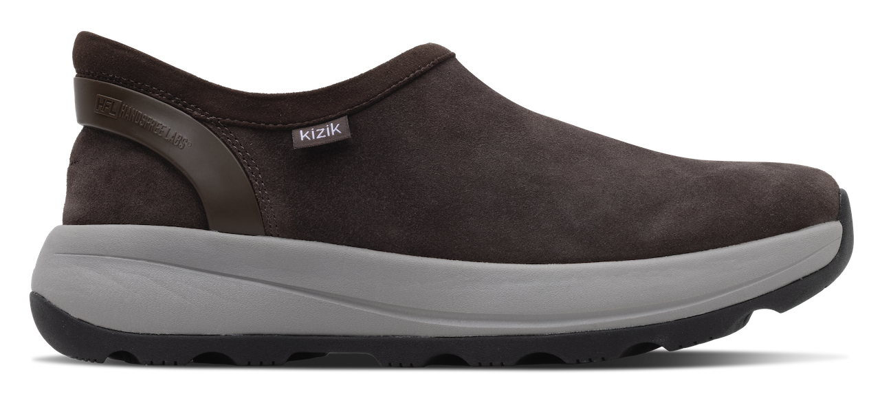 A dark brown slip-on shoe with a textured suede-like upper, a gray midsole, and a black outsole, shown from a side profile view on a white background.