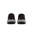 A pair of Kizik brand slip-on shoes shown from the back, featuring dark brown upper straps and a light gray sole with the brand name 'kizik' printed on it.