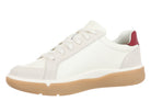 A low-top white sneaker with a gum-colored sole and a small red accent on the heel, shown from a side profile on a white background.