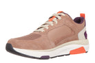 A low-top athletic sneaker in a dusty rose and beige colorway, featuring a chunky white midsole with bright orange accents, a purple heel tab, and a black outsole.
