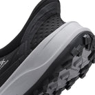 Close-up of a black and gray hiking shoe with a brand logo on a white background