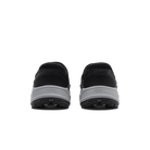 A pair of black slip-on shoes shown from the back, featuring a textured black upper and a thick light gray midsole with the brand name 'KZIK' embossed on it, set against a plain white background.