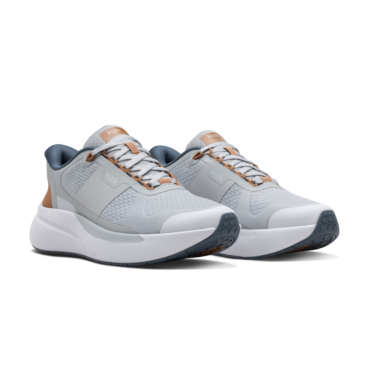 Pair of gray athletic shoes with brown accents on a black background