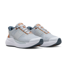 Pair of gray athletic shoes with brown accents on a black background