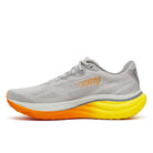 Gray running shoe with orange sole on a white background