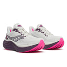 White running shoes with pink soles on a white background