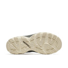 The sole of a Merrell hiking shoe in a light beige rubber with a dark gray upper, shown from a top-down view on a white background.