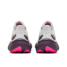 White athletic shoes with pink soles on a white background