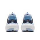 A pair of athletic sneakers shown from the back, featuring a navy blue and light blue upper with a thick white sole.
