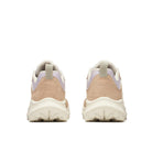 Pair of beige sneakers with white soles on a white background
