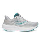 A light gray Saucony running shoe with a thick white midsole and teal accents on the logo, collar lining, and outsole, shown from a side profile on a white background.