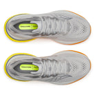 Pair of gray running shoes with yellow sole on a white background