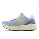 A New Balance running shoe in light blue and purple with a yellow 'N' logo and a cream-colored midsole, shown from a side profile on a white background.