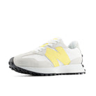 White sneaker with yellow accents on a white background