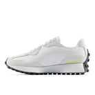 White sneaker with black sole on a white background