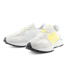 White sneakers with yellow accents on a white background