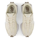 Pair of cream-colored sneakers with a brand logo on a white background