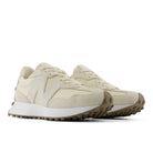 Pair of beige sneakers on a white background