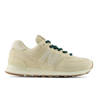 Beige sneaker with green laces on a white background