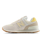 Beige sneaker with brown sole on a white background