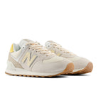 Beige sneakers with brown soles on a white background