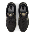 A pair of black New Balance sneakers shown from a top-down view, featuring leopard print accents on the tongue and heel collar, black laces, and a white midsole.