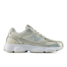 Silver sneaker with New Balance logo on a white background