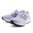 Pair of lavender running shoes with black accents on a white background