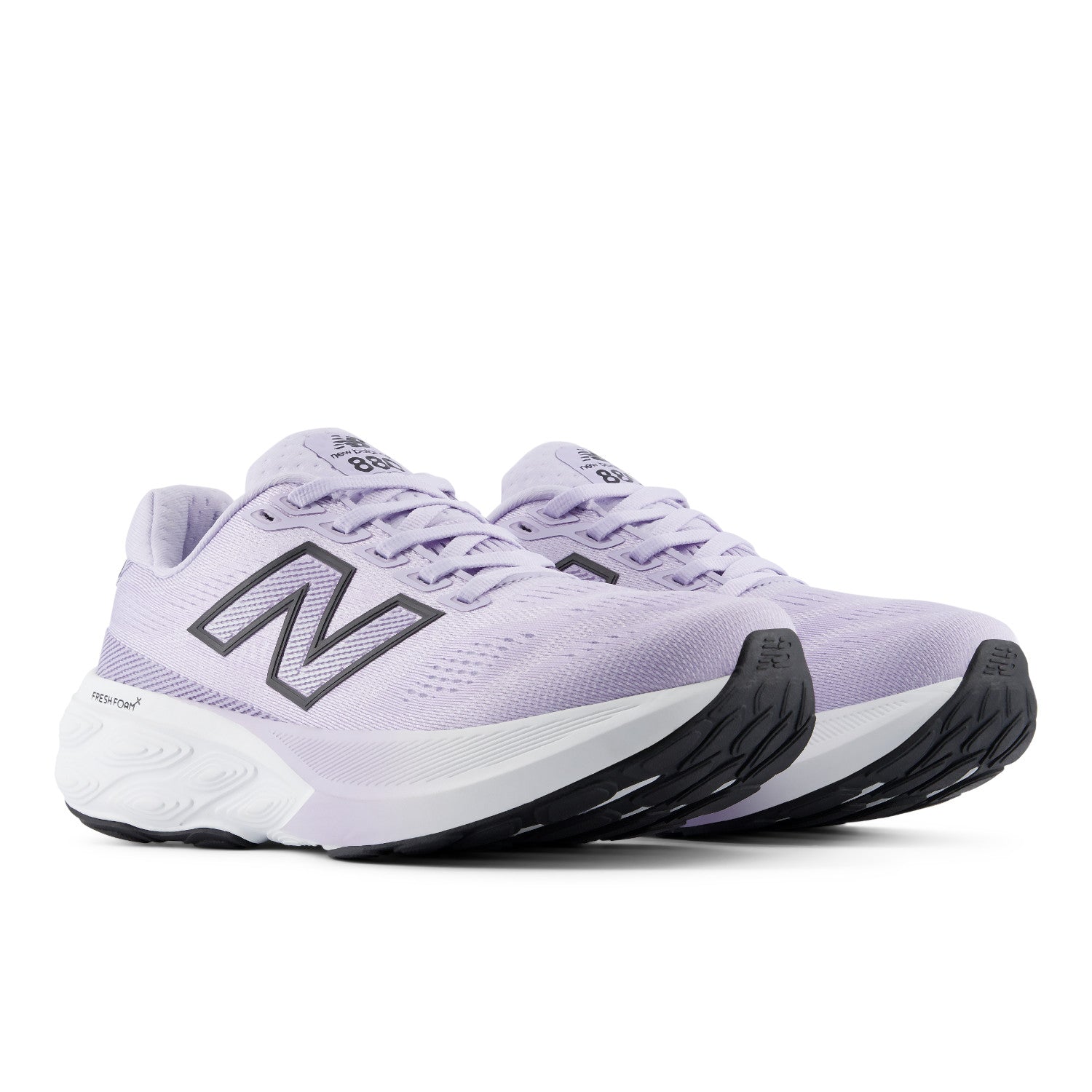 Pair of purple running shoes with New Balance logo on a white background